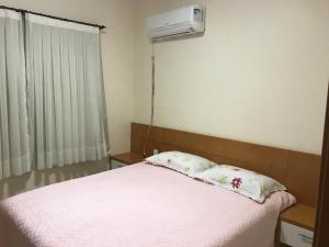 a bedroom with a bed and a air conditioner on the wall at Fleixeiras Eco Residence in Trairi +82 photos