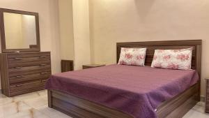 a bedroom with a bed with a mirror and a dresser at The Mountain View in Ash Shāghūr +21 photos