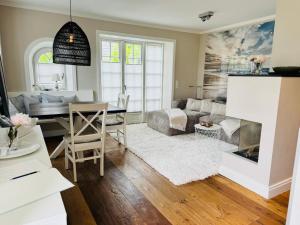 a living room with a table and a couch at Haus Magnus SeaSide in Sylt