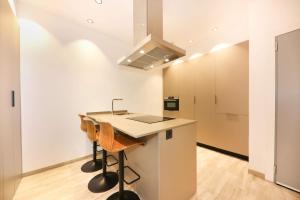 a kitchen with a counter and a sink in a room at Domus Halo F in Pamplona