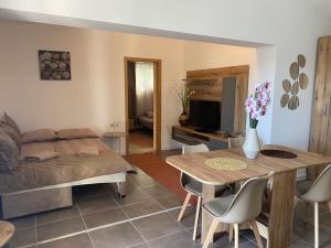 a living room with a bed and a table with chairs at Villa Radis in Dobra Voda
