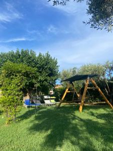 a gazebo in the grass with a picnic table at Un Passo Dal Mare in Lido di Fermo