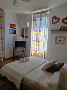a bedroom with a large bed and a window at La Casetta di Benedetta in Rome