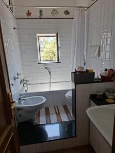 a bathroom with a tub and a sink and a toilet at La Casetta di Benedetta in Rome
