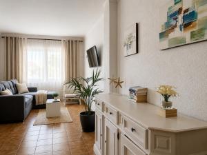a living room with a couch and a table at BRESSOL DELUXE Apartments in Port de Pollensa
