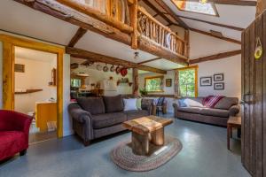 a living room with couches and a table at Woods End Landing in Bamfield
