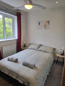 a bedroom with a bed with two pillows on it at Grace's Place in Milton in Milton