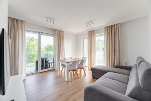 a living room with a couch and a table at Helskafoka2 in Hel