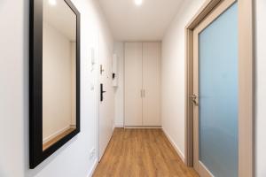 a hallway with a mirror on the wall next to a door at Helskafoka2 in Hel