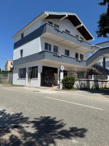 a large white building on the side of a street at Villa DEA in Velipojë