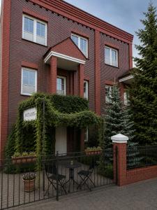 a red brick building with a table in front of it at Villa Jeziorki in Warsaw