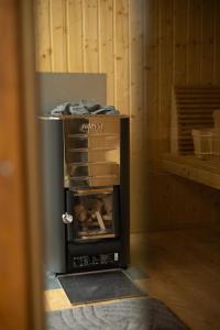 a small stove in a room with a box at Bizon Cabin in Albeștii de Muscel