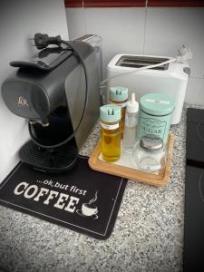 a coffee maker and a sign on a counter at A vacation by the sea in Puerto de Sagunto +8 photos