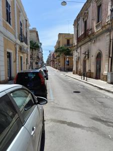 a street with cars parked on the side of the road at Giordano Bruno 8 in Brindisi