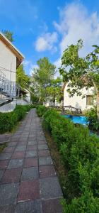 a stone walkway next to a building and a river at Gabala Semerana Hotel Cottage in Gabala