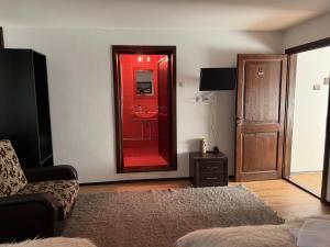 a living room with a mirror and a couch at Casa Mario in Dragoslavele