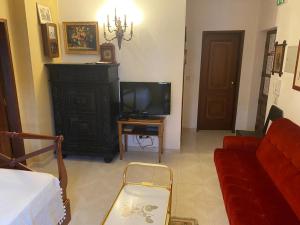 a living room with a tv and a couch at Vintage Apartment in Vila Nova de Milfontes +5 photos