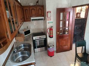 a kitchen with a sink and a stove at Vintage Apartment in Vila Nova de Milfontes
