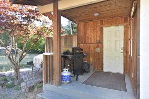 a barbecue inside of a wooden building with a door at Equus Acres in Boston Bar
