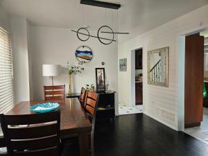 a dining room with a wooden table and chairs at Cozy and comfortable home - Living room and Kitchen is shared in Pickering