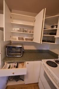 a kitchen with white cabinets and a stove at Equus Acres in Boston Bar +3 photos