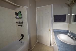 a bathroom with a sink and a tub and a toilet at Equus Acres in Boston Bar