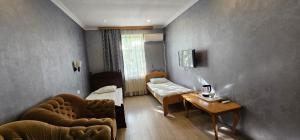 a room with a couch and a bed and a table at Gabala Semerana Hotel Cottage in Gabala