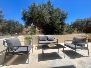 a patio with two chairs and a table at Sea and Sand Elafonisos in Elafonisos