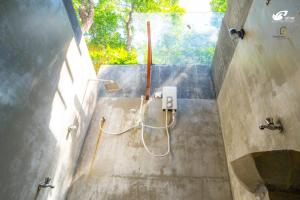 a bathroom with a showerivedivedivedivedivedivedivedivedivedivedived at Bathle Eco Resort in Mawanella
