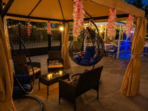 a gazebo with two chairs and a swing at Hotel Jacob in Ureki +60 photos