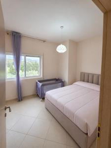 a bedroom with a large bed and a window at At Konan's in Vlorë +16 photos