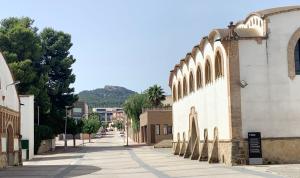 an empty street in a town with a building at Garbinada in Gandesa