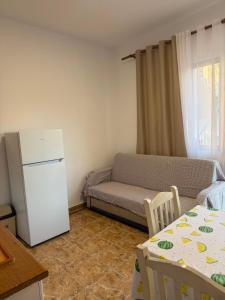a living room with a couch and a refrigerator at Villa DEA in Velipojë +42 photos