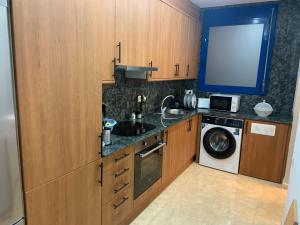 a kitchen with a sink and a washing machine at Garbinada in Gandesa