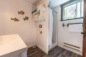a bathroom with a sink and a window at Woods End Landing in Bamfield +225 photos