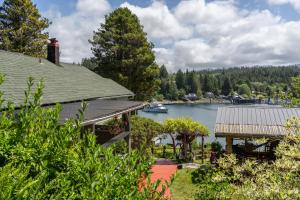 a house with a view of a river and a boat at Woods End Landing in Bamfield