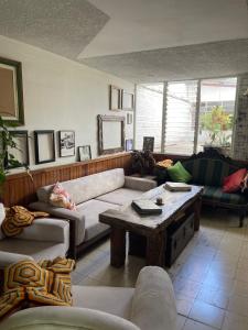 a living room with couches and a coffee table at Hostal Casa Las Tías in Medellín