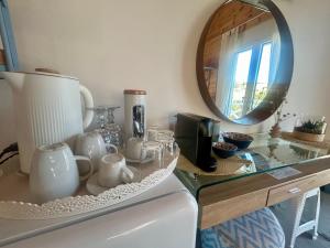 a bathroom with a counter with a mirror and a sink at Sea and Sand Elafonisos in Elafonisos +21 photos