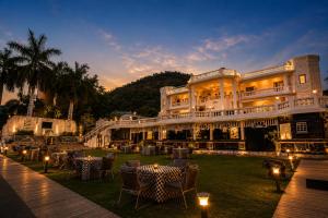 a large building with tables and chairs in front of it at Victoria Mansion - A Signature Collection by HST Hotels in Udaipur