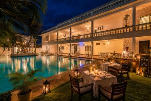 a restaurant with a pool in front of a building at Victoria Mansion - A Signature Collection by HST Hotels in Udaipur