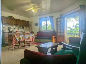 a living room with a table and a dining room at Villa Étage Z Irma in Antsiranana