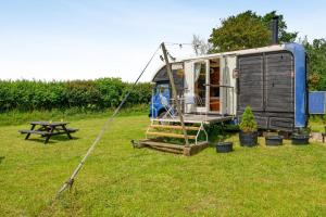 an rv parked in a field with a picnic table at 1 Bed in Elsing oc-d44229 in Elsing +14 photos