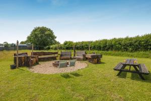 a park with benches and a picnic table in the grass at 1 Bed in Elsing oc-d44229 in Elsing