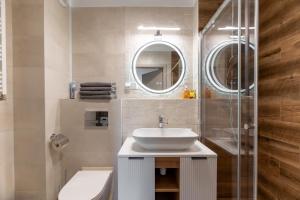 a bathroom with a sink and a shower at Helskafoka2 in Hel +3 photos