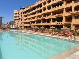 a large swimming pool in front of a hotel at Musa apartamentos in El Ejido