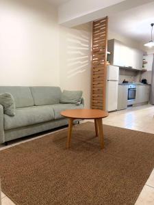 a living room with a couch and a coffee table at Litmus apartment 4 in Karlovasi +3 photos