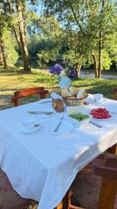 a white table with plates of food on it at Cabañas Loncoche Puerta del Sol in Loncoche