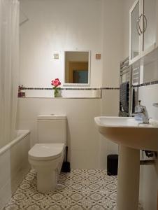 a white bathroom with a toilet and a sink at Little Paradise Marlborough in Marlborough +30 photos