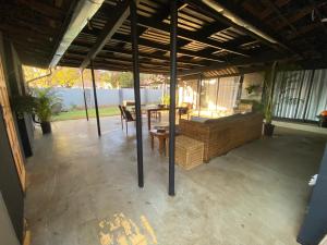 a patio with a table and chairs in a house at Slaapnet Guesthouse Long Stay Accommodation Wilkoppies in Klerksdorp
