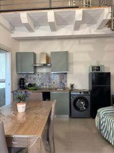 a kitchen with a wooden table in a room at Sole di Sicilia in Locogrande
